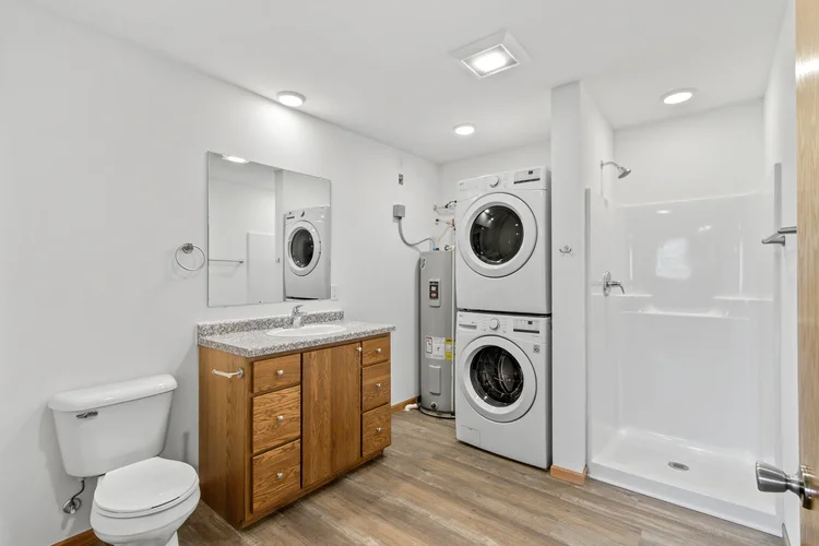 Greenfield Estates studio — bathroom with in-unit washer and dryer